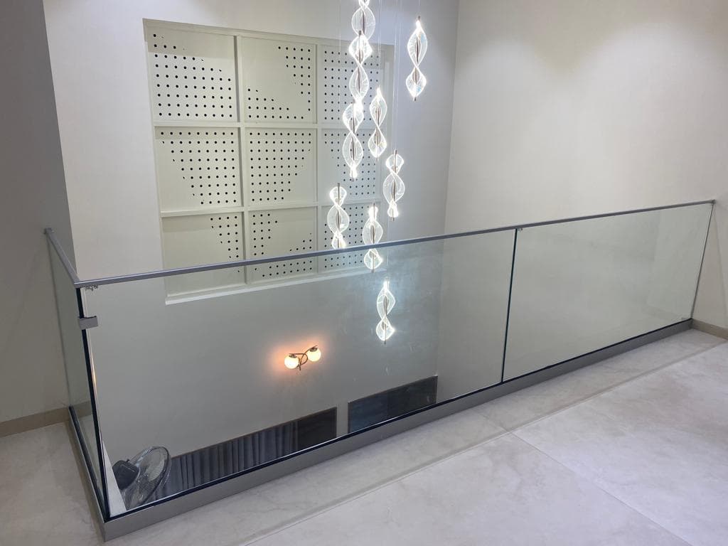 Interior glass railing with a metal base channel