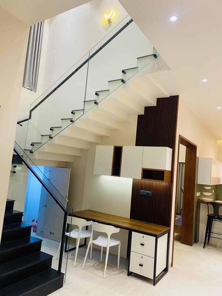 Staircase glass railing seen from below in a home interior
