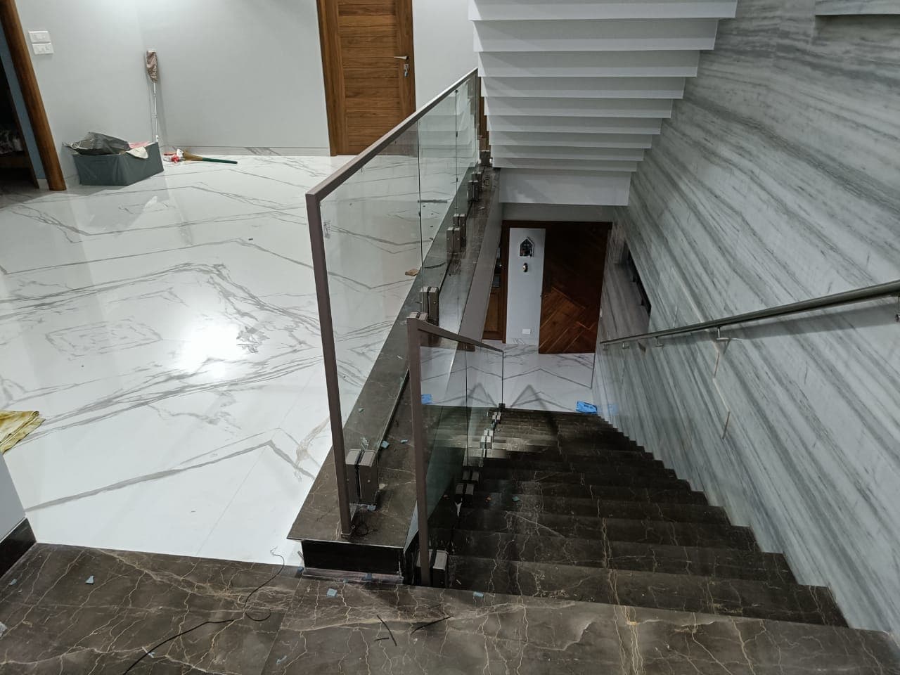 Staircase glass railing viewed from the top landing