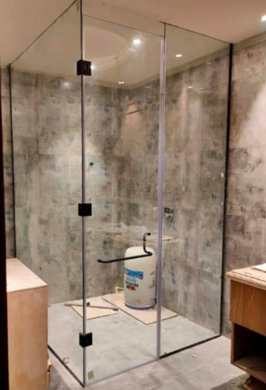 Frameless glass shower enclosure in a bathroom