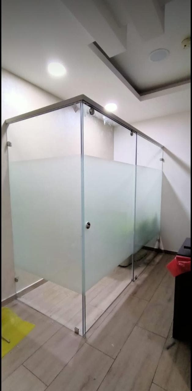 Corner glass shower enclosure with a frosted lower panel